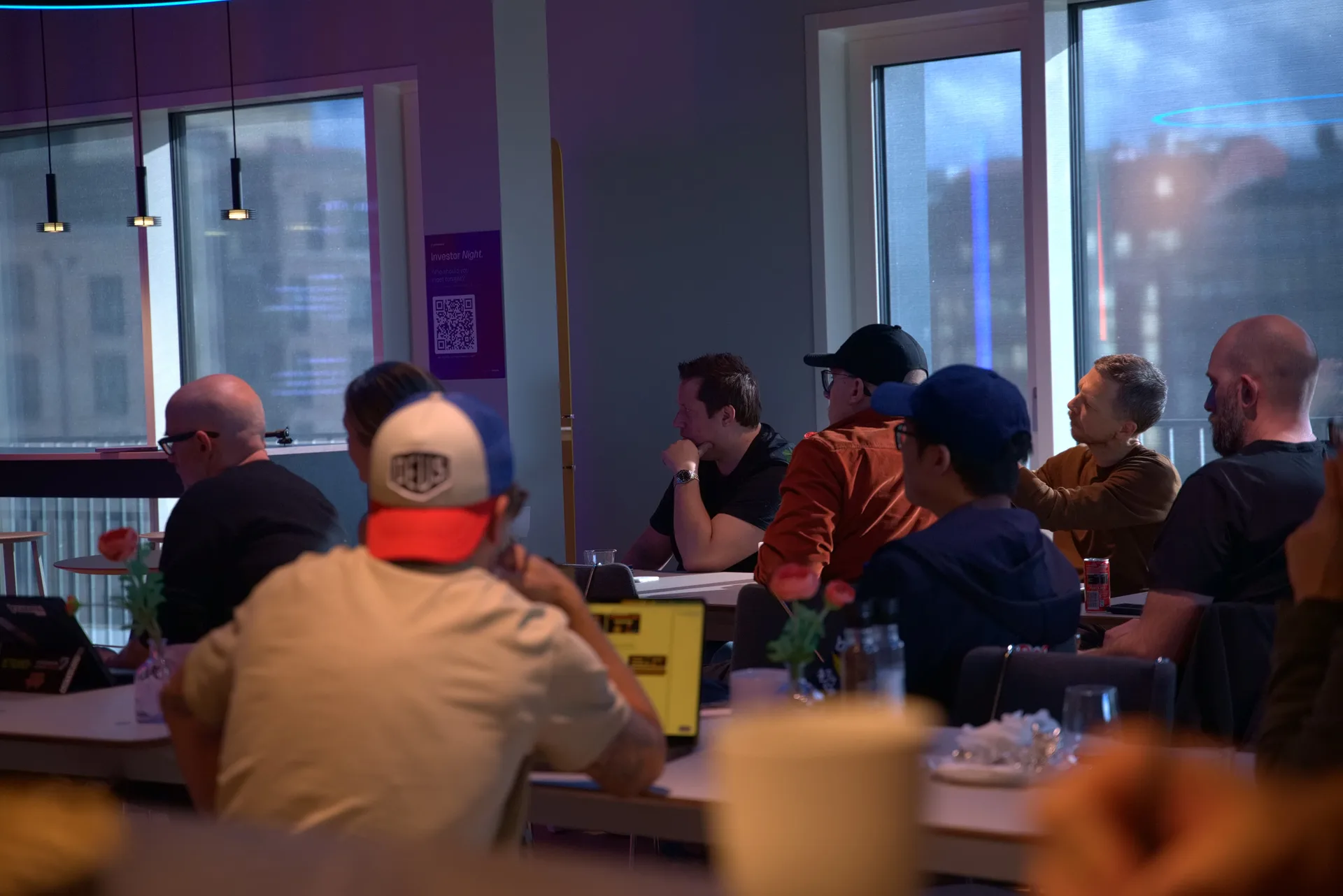 Founders listening at the long tables by the windows