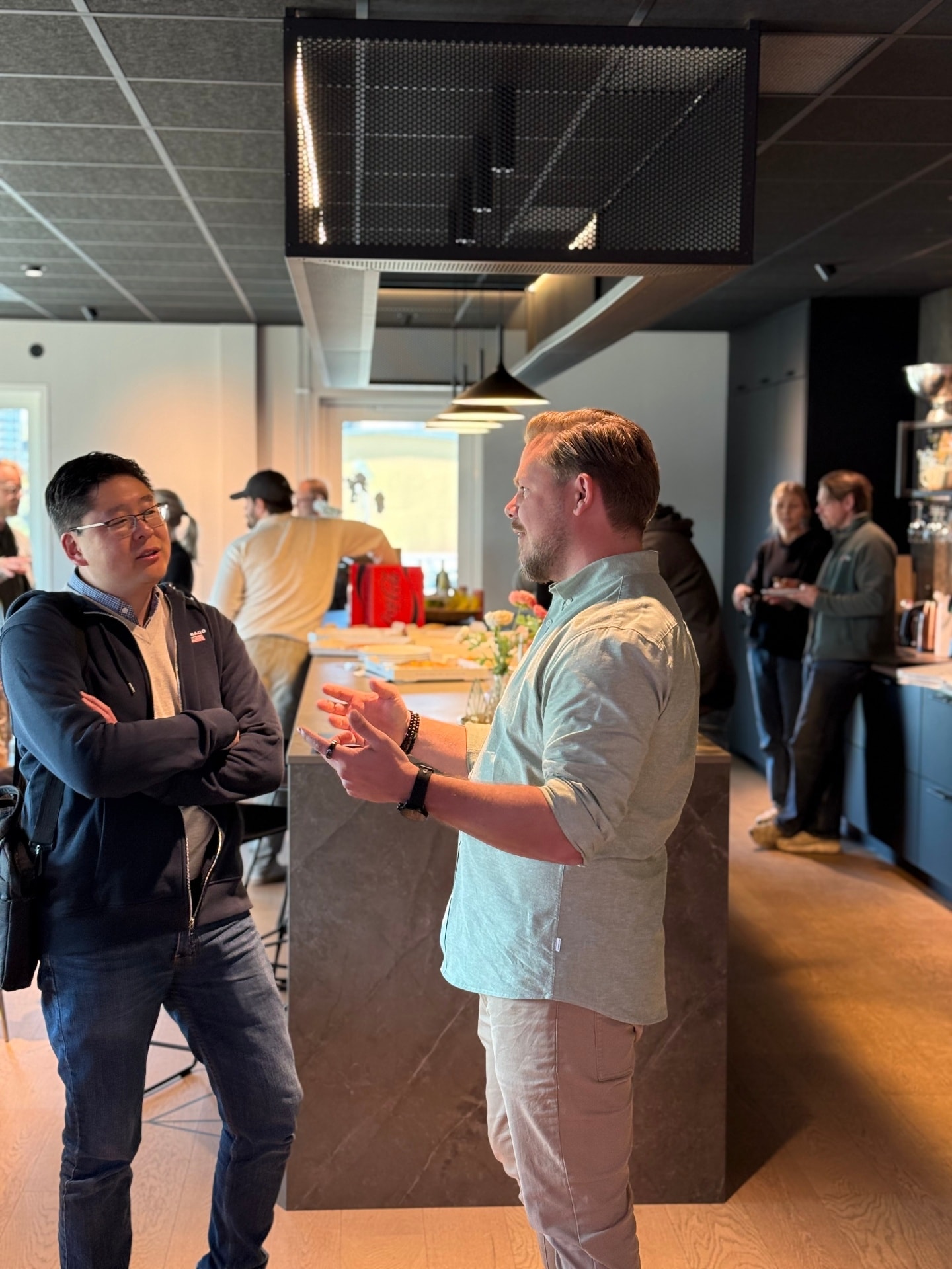 A founder meeting an angel investor in the corner of the room